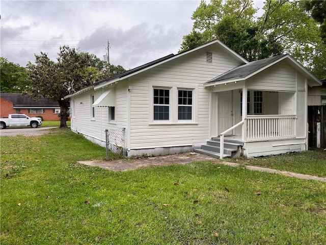 bungalow-style house with a porch and a front yard