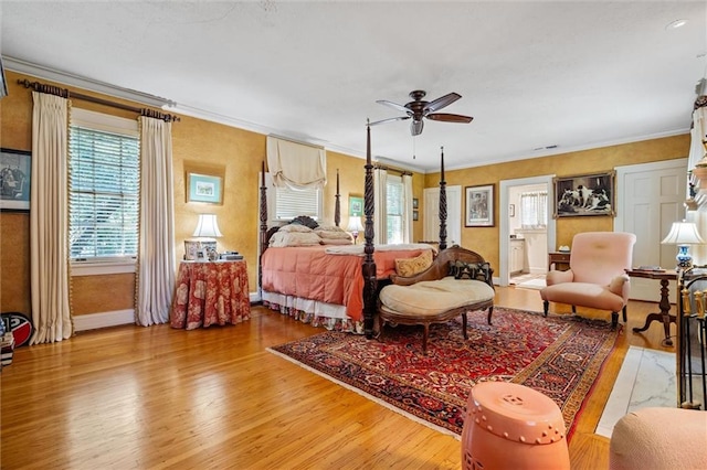 bedroom featuring ceiling fan, light hardwood / wood-style floors, and ornamental molding