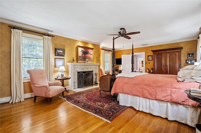 bedroom with ceiling fan, light hardwood / wood-style flooring, and ornamental molding