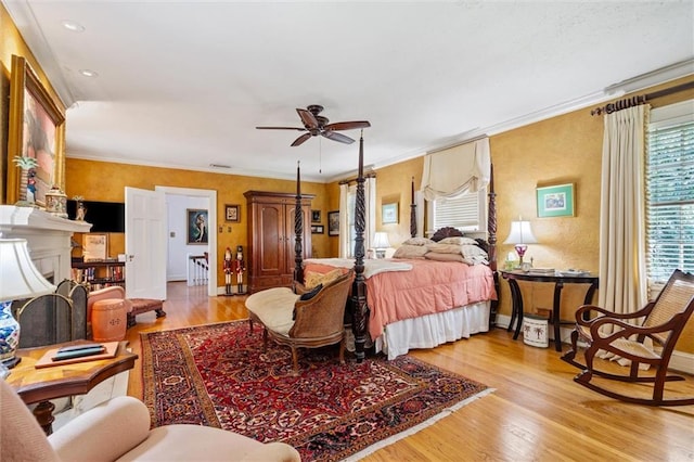 bedroom with ceiling fan, light hardwood / wood-style floors, and ornamental molding