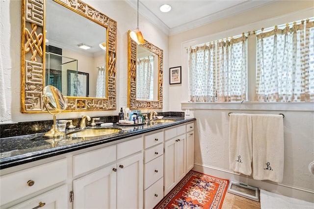 bathroom with tile patterned flooring, crown molding, and vanity