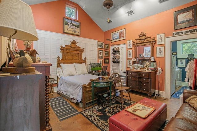 bedroom featuring high vaulted ceiling, stainless steel fridge, tile patterned flooring, and multiple windows