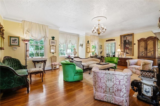 living room featuring a textured ceiling, hardwood / wood-style floors, and an inviting chandelier