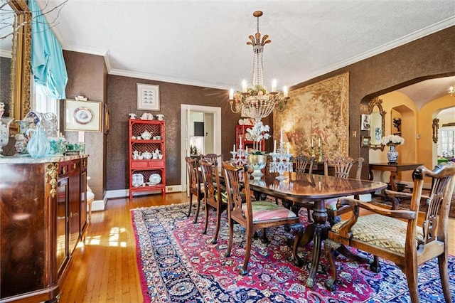 dining room with plenty of natural light, an inviting chandelier, and hardwood / wood-style flooring