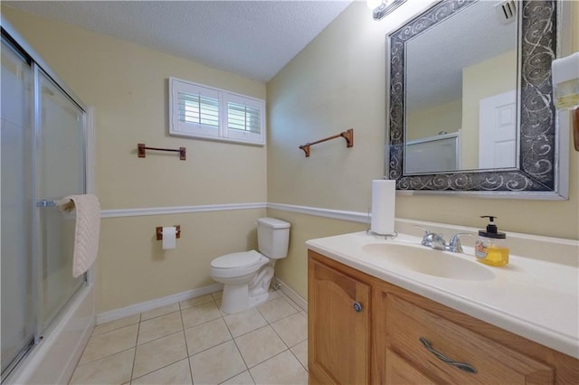 full bathroom with shower / bath combination with glass door, vanity, a textured ceiling, tile patterned floors, and toilet