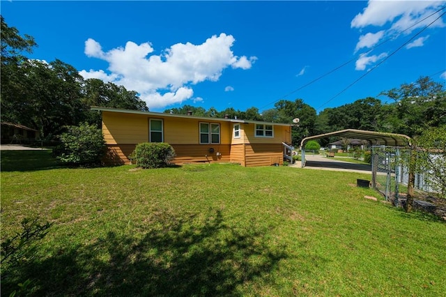 view of front facade with a front yard and a carport