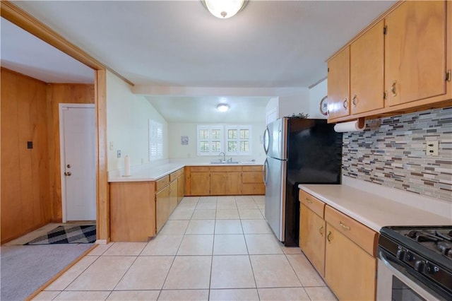 kitchen with sink, light tile patterned floors, stainless steel appliances, and tasteful backsplash