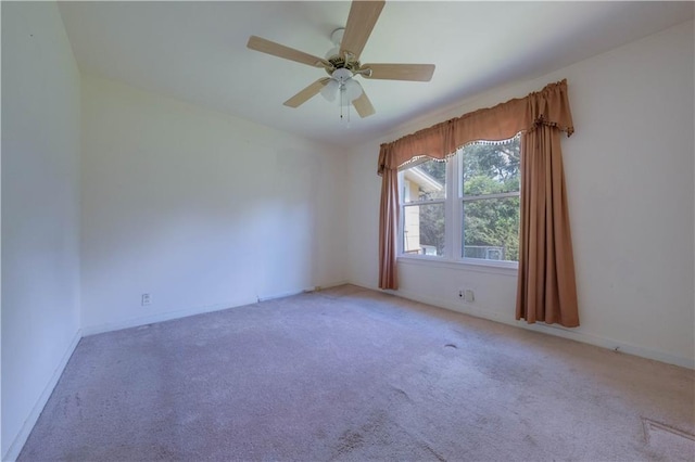 unfurnished room featuring ceiling fan and light colored carpet