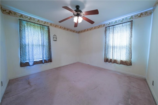 carpeted spare room featuring ceiling fan