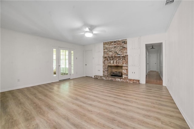 1008 Chalet Dr W, Mobile, AL 36608 - unfurnished living room featuring ceiling fan, light wood-style floors, and a fireplace
