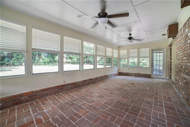 1008 Chalet Dr W, Mobile, AL 36608 - unfurnished sunroom with plenty of natural light, brick floors, and brick wall