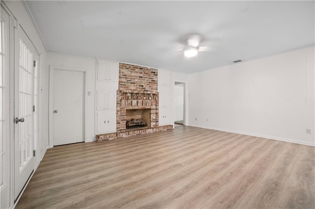 1008 Chalet Dr W, Mobile, AL 36608 - unfurnished living room featuring light wood-style flooring, a brick fireplace, and a ceiling fan