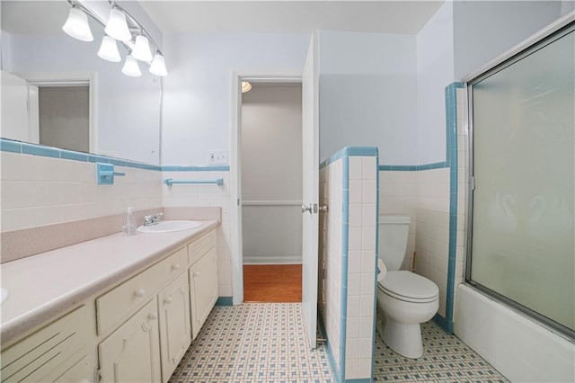 1008 Chalet Dr W, Mobile, AL 36608 - full bath with tile walls, vanity, wainscoting, tile patterned floors, and bath / shower combo with glass door