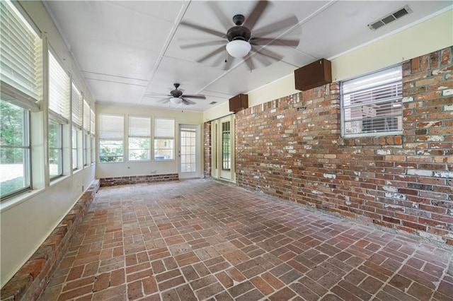 1008 Chalet Dr W, Mobile, AL 36608 - unfurnished sunroom featuring brick wall and brick flooring