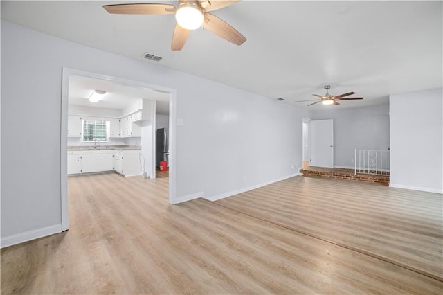 1008 Chalet Dr W, Mobile, AL 36608 - empty room with ceiling fan and light wood-style floors