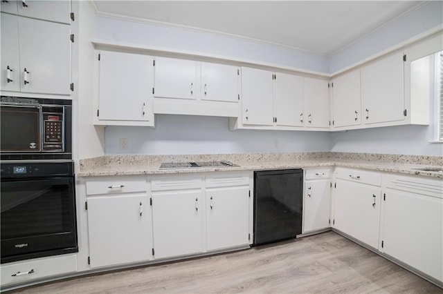 1008 Chalet Dr W, Mobile, AL 36608 - kitchen featuring black appliances, light wood-style flooring, white cabinetry, and under cabinet range hood