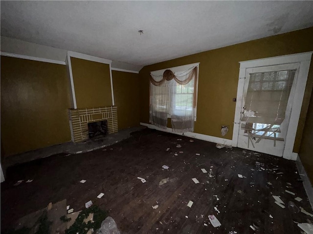 unfurnished living room featuring a brick fireplace