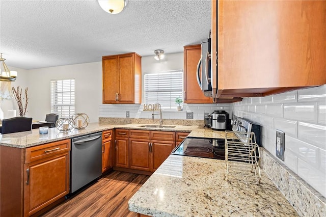 kitchen featuring light hardwood / wood-style flooring, stainless steel appliances, sink, and a wealth of natural light