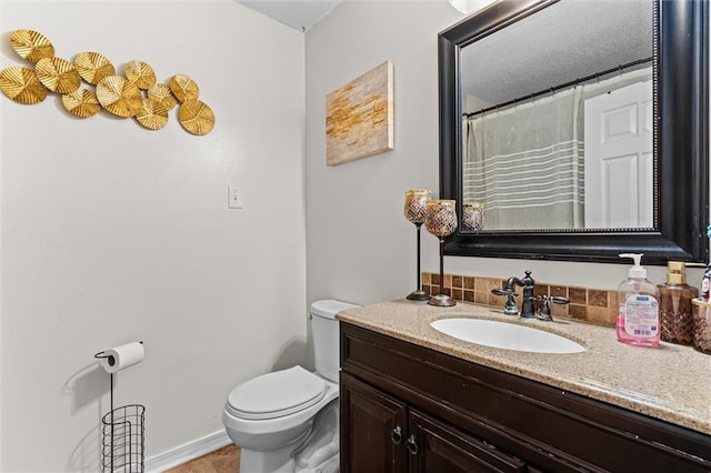 bathroom with vanity, toilet, and tile patterned floors