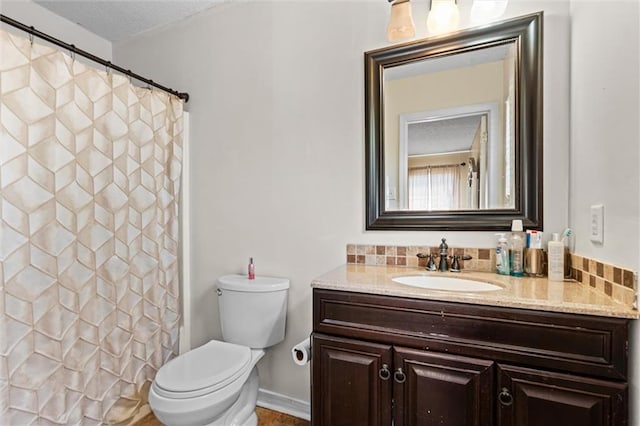 bathroom featuring vanity, toilet, and a textured ceiling