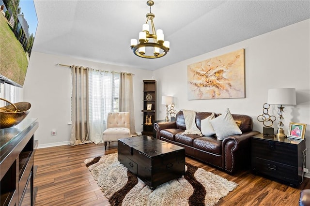 living room with an inviting chandelier and dark hardwood / wood-style flooring