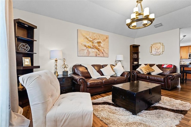 living room with a notable chandelier and wood-type flooring