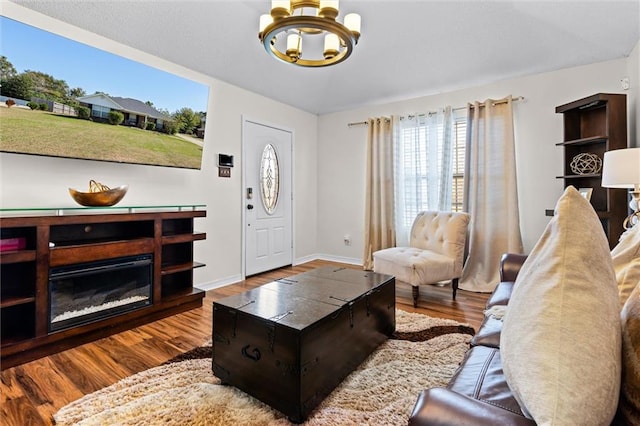 living room with hardwood / wood-style floors and a notable chandelier