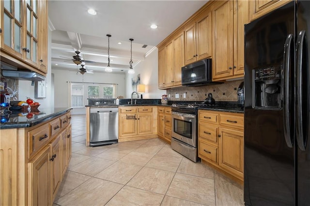 kitchen with dark stone countertops, decorative light fixtures, black appliances, kitchen peninsula, and ceiling fan