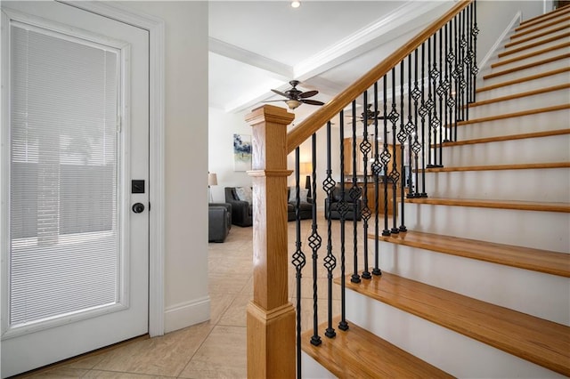 staircase with tile patterned flooring, crown molding, and ceiling fan