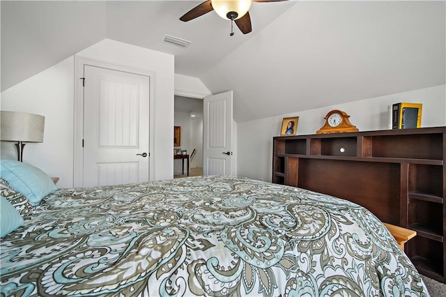 bedroom featuring lofted ceiling, ceiling fan, and a closet