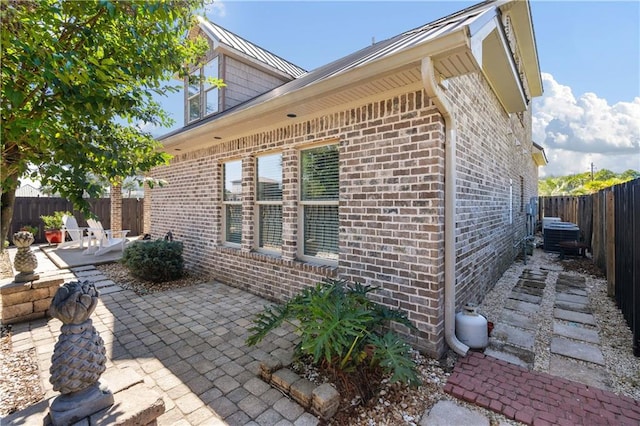 view of side of property featuring a patio area