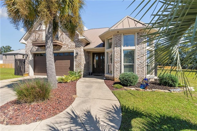 view of front facade with a front yard and a garage