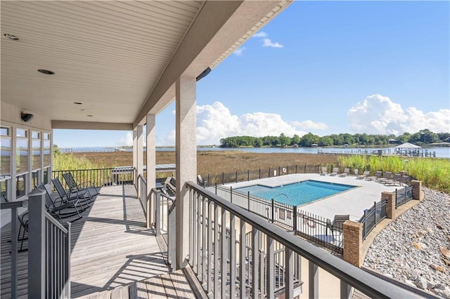 exterior space with a community pool and a water view