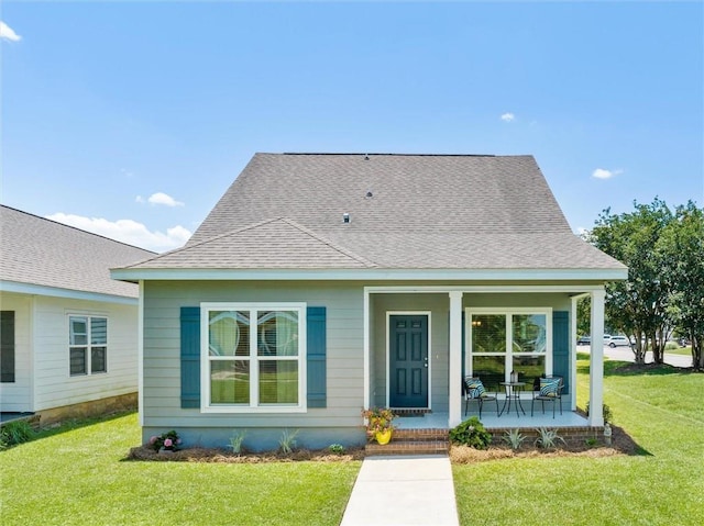 bungalow-style home featuring a porch and a front lawn