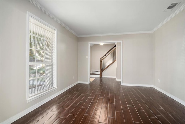 spare room featuring plenty of natural light, ornamental molding, and dark hardwood / wood-style flooring