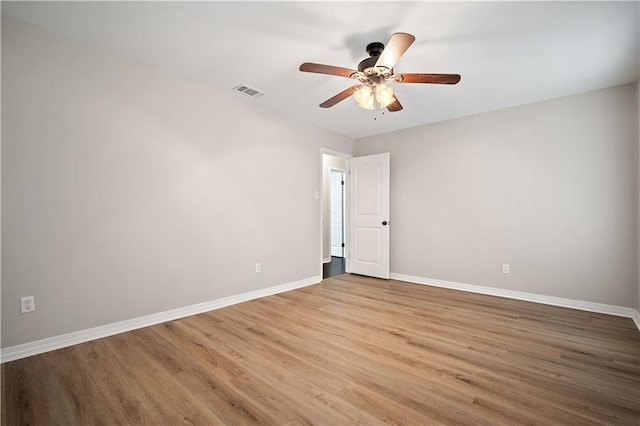 empty room featuring ceiling fan and light hardwood / wood-style floors