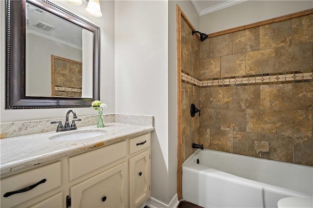 full bathroom featuring crown molding, toilet, vanity, and tiled shower / bath combo