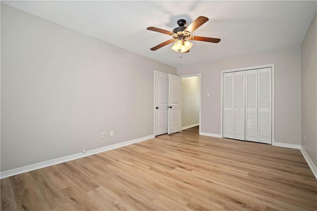 unfurnished bedroom featuring ceiling fan, a closet, and light hardwood / wood-style flooring