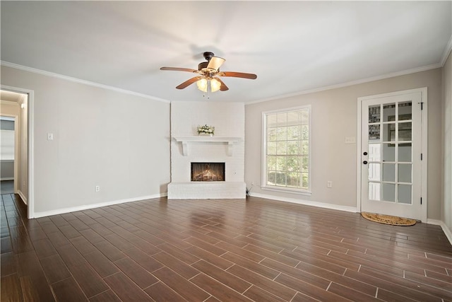 unfurnished living room featuring ceiling fan, ornamental molding, a fireplace, and dark wood-type flooring