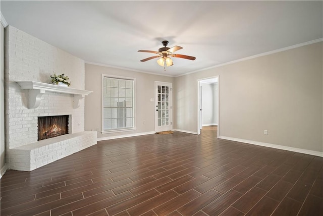 unfurnished living room featuring ceiling fan, a fireplace, crown molding, and dark hardwood / wood-style floors