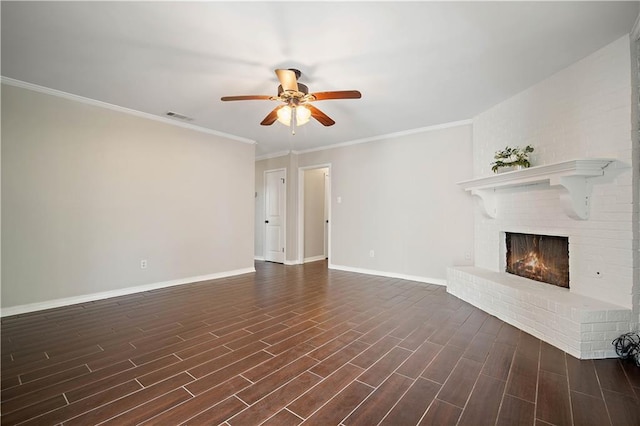 unfurnished living room with dark wood-type flooring, a brick fireplace, crown molding, and ceiling fan