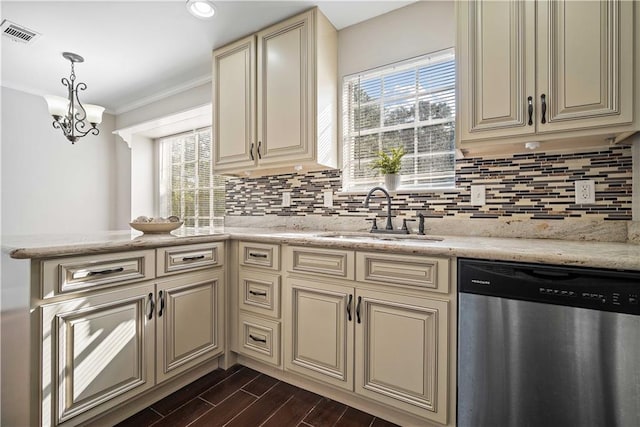 kitchen with stainless steel dishwasher, sink, hanging light fixtures, ornamental molding, and cream cabinetry