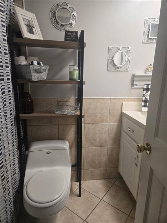 1832 Aden Rd, Mobile, AL 36695 - bathroom featuring tile walls, tile patterned floors, toilet, a wainscoted wall, and vanity