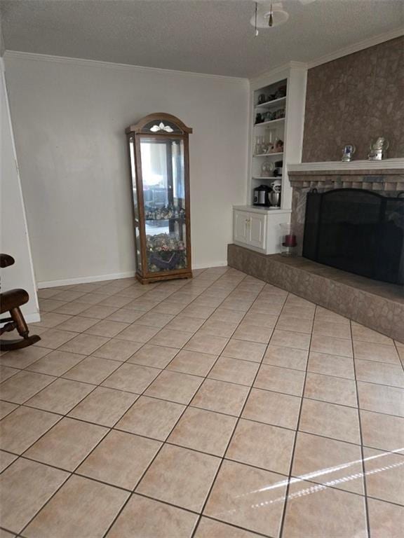 1832 Aden Rd, Mobile, AL 36695 - unfurnished living room featuring built in shelves, ornamental molding, a textured ceiling, light tile patterned floors, and a fireplace with raised hearth