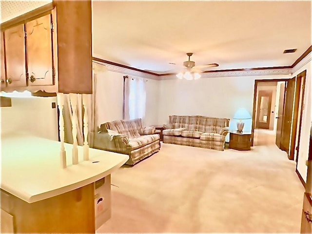 carpeted living room with ceiling fan and ornamental molding