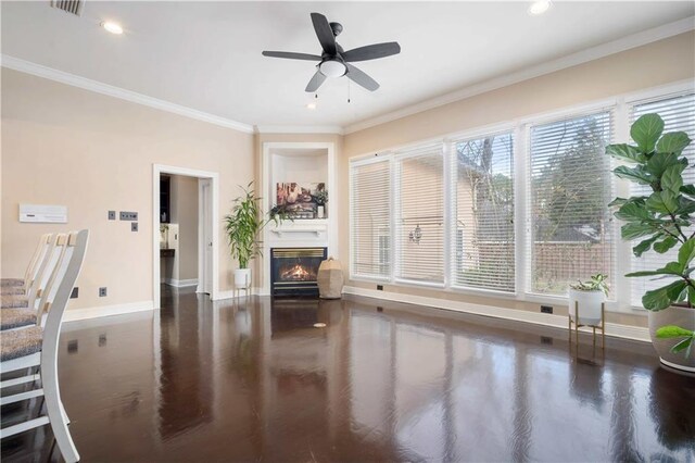 6721 Stonebrook Dr N, Mobile, AL 36695 - living area with baseboards, a glass covered fireplace, crown molding, wood finished floors, and a ceiling fan