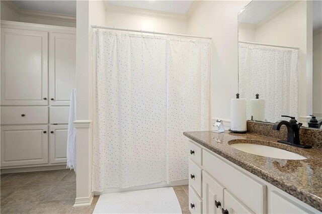 6721 Stonebrook Dr N, Mobile, AL 36695 - bathroom featuring vanity, crown molding, curtained shower, tile patterned floors, and baseboards
