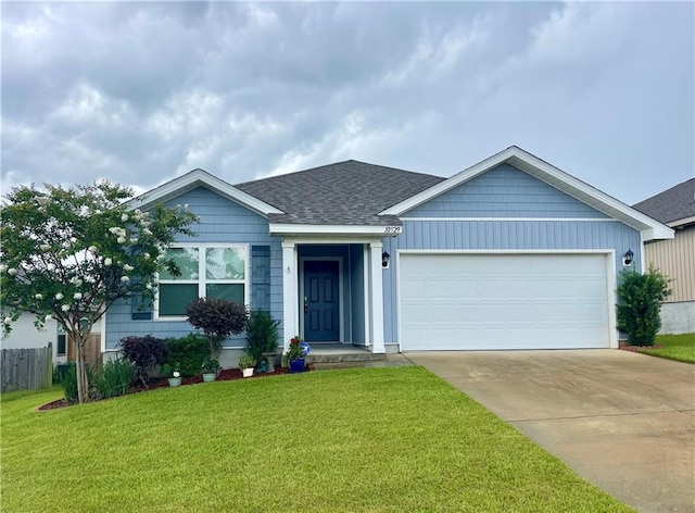 10529 Wales Ln, Spanish Fort, AL 36527 - ranch-style home with driveway, roof with shingles, an attached garage, and a front yard