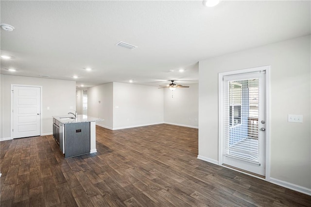 10529 Wales Ln, Spanish Fort, AL 36527 - kitchen with dark wood-style floors, an island with sink, a ceiling fan, light stone counters, and recessed lighting