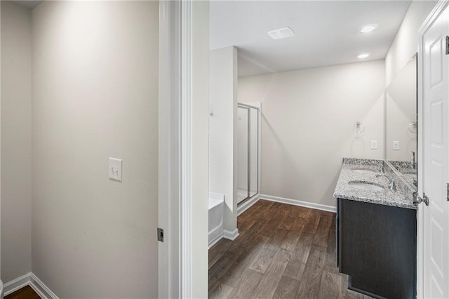 10529 Wales Ln, Spanish Fort, AL 36527 - full bathroom with double vanity, a stall shower, wood finished floors, a bathtub, and recessed lighting